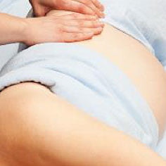 a lady having a pregnancy massage